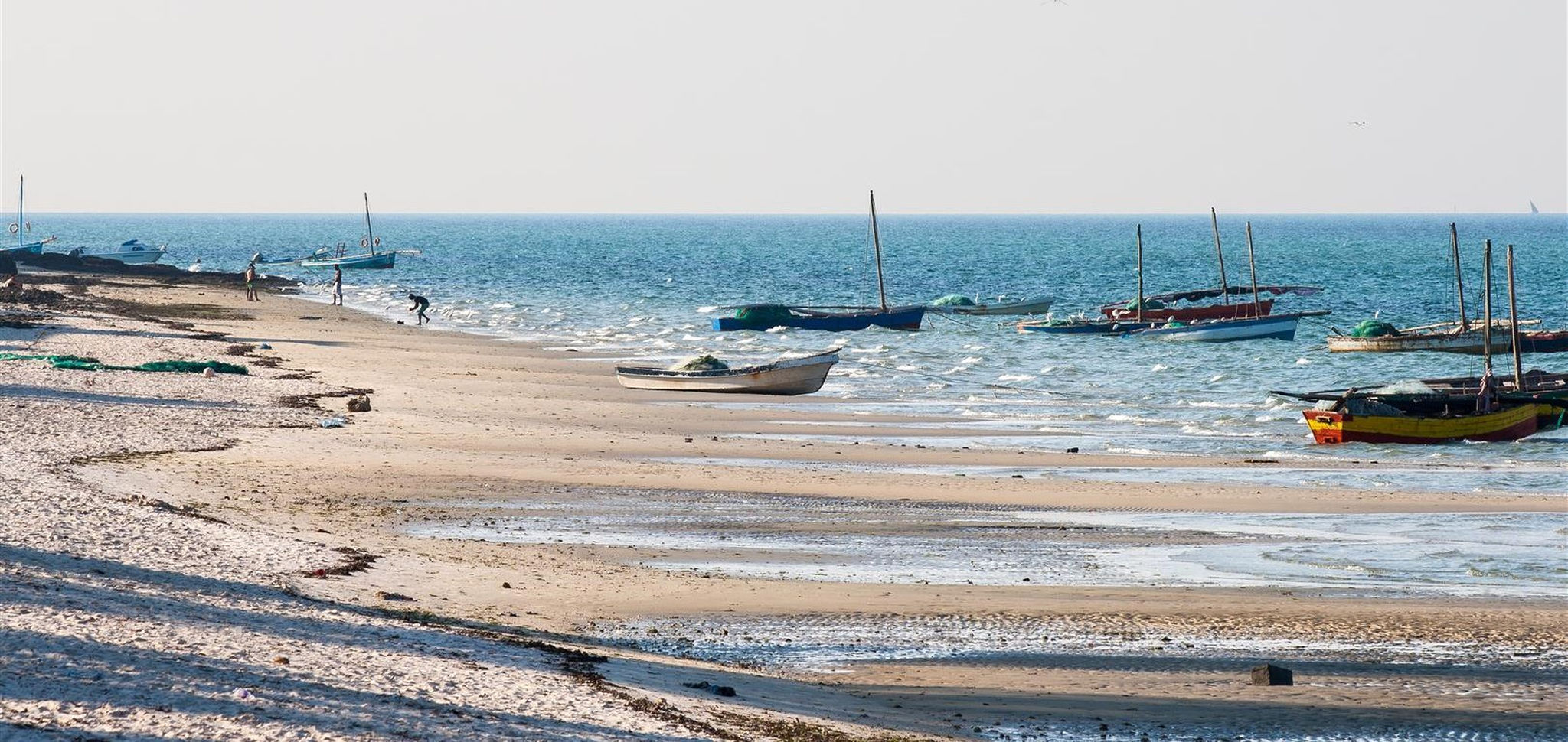 Mozambique beach filled with dhows and locals at Vilanculos